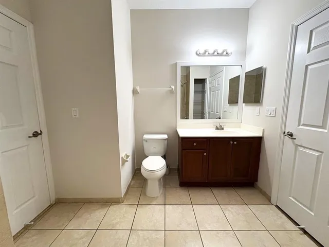 a bathroom with a sink a toilet and mirror