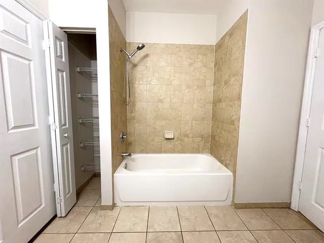 a bathroom with a bathtub and shower