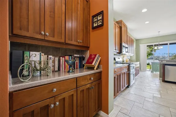 a kitchen with stainless steel appliances kitchen island granite countertop a sink and cabinets