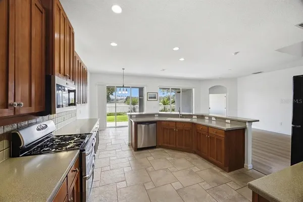 a large white kitchen with a large window