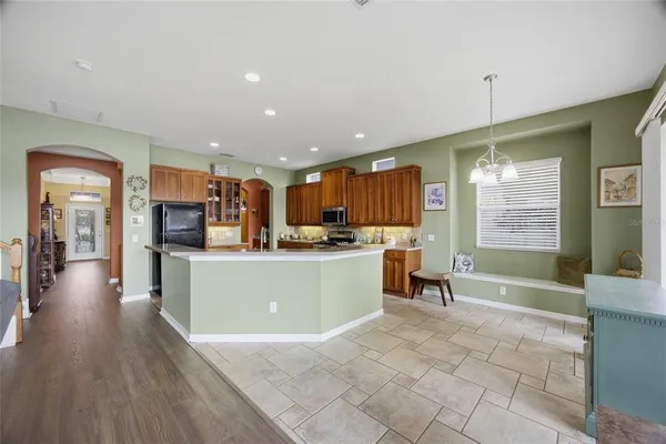 an empty room with a window and ceiling fan