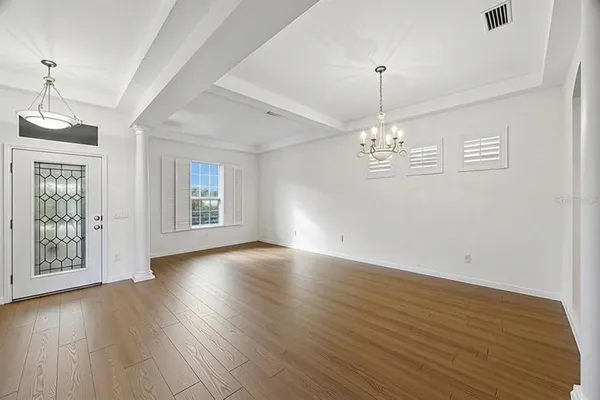 a dining room with furniture and wooden floor