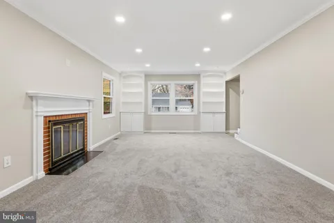 a view of empty room with a fireplace