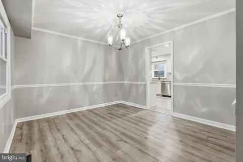 a view of wooden floor and windows in a room