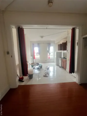 a view of a livingroom with furniture window and wooden floor