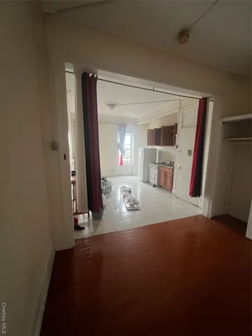 a view of a livingroom with wooden floor and a cabinet