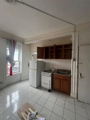 a kitchen with a stove top oven and cabinets