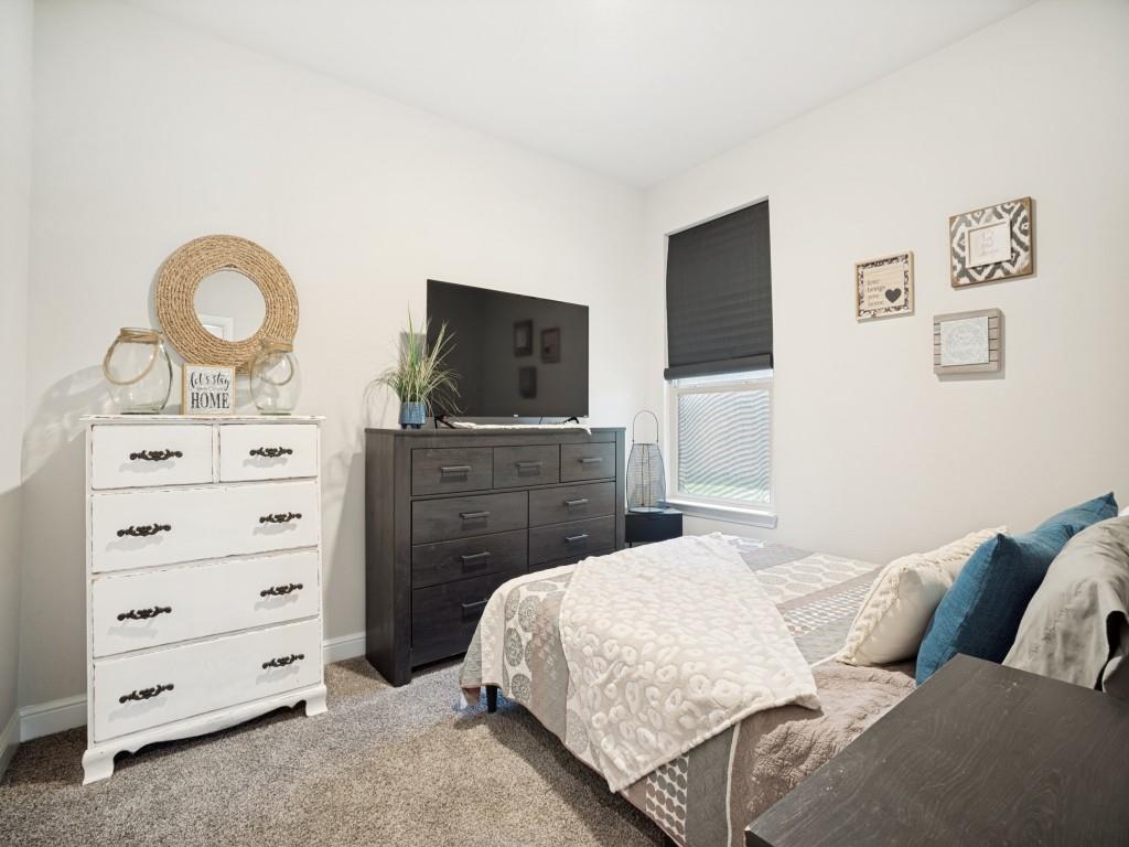 1612 Reed Drive Krum, TX 76249 - Photo 19 of 25 Plush carpet flooring complements neutral wall tones within this private room