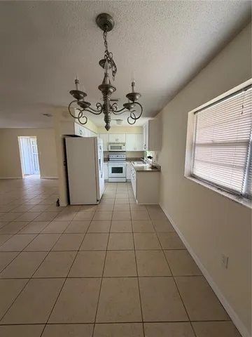 a kitchen with stainless steel appliances a sink stove and cabinets