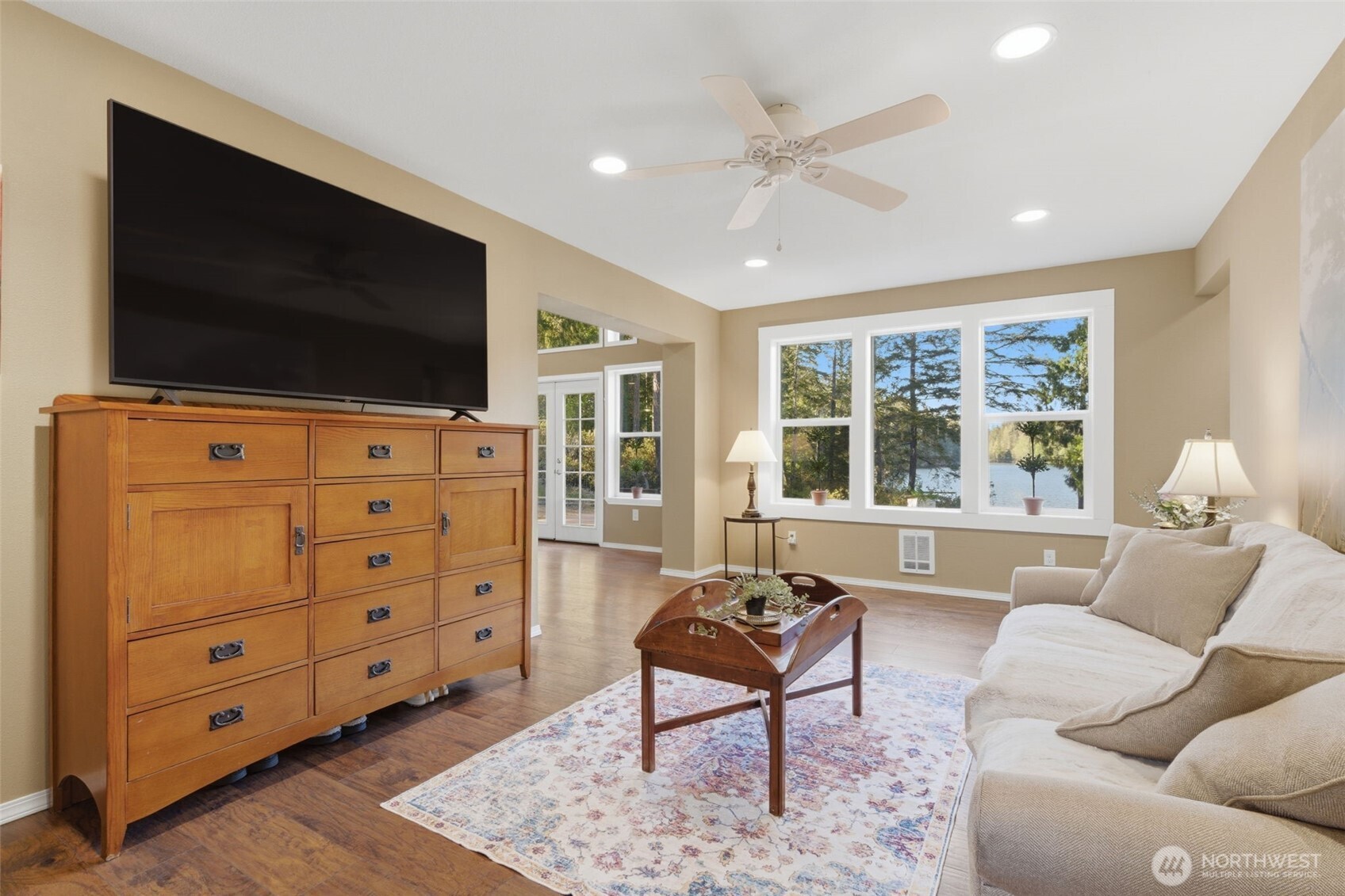 6971 Northeast Tahuya Blacksmith Road Belfair, WA 98528 - Photo 6 of 38 a living room with furniture and a flat screen tv