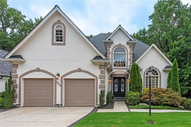a front view of a house with a yard and garage