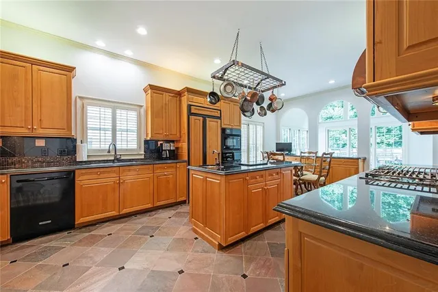 a kitchen with stainless steel appliances granite countertop a sink and cabinets