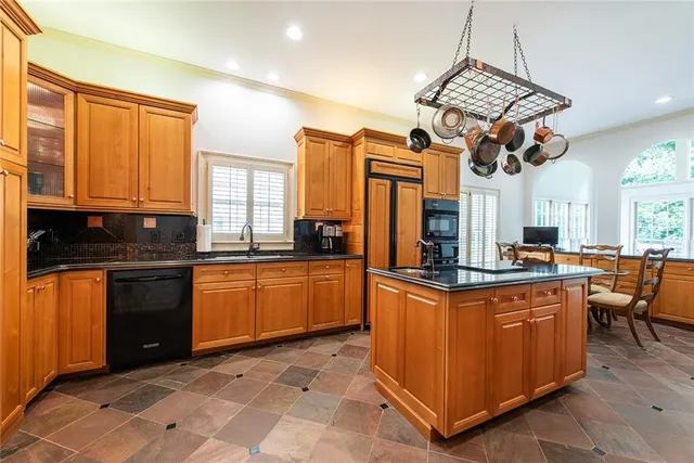 a kitchen with stainless steel appliances granite countertop sink stove and cabinets