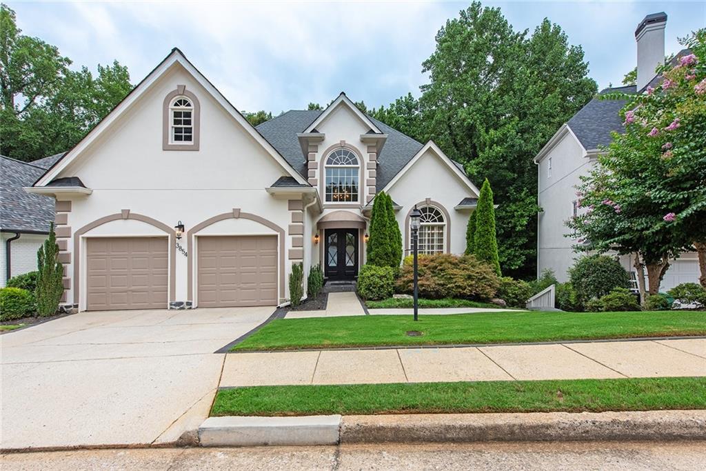 3854 Sidestreet Atlanta, GA 30341 - Photo 2 of 83 a front view of a house with a yard and garage