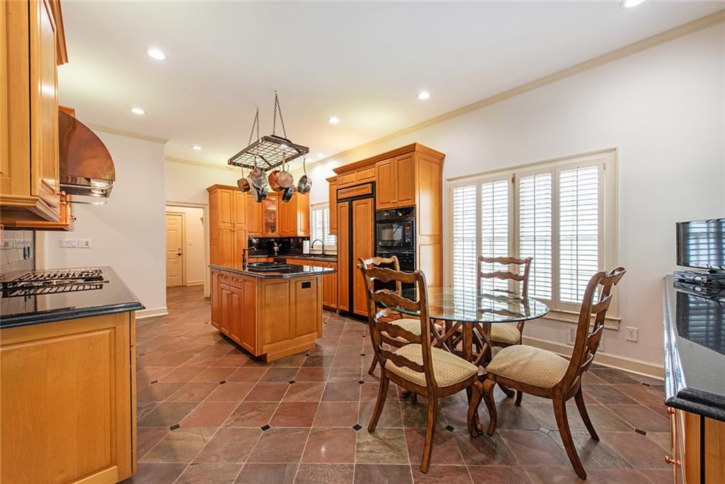 3854 Sidestreet Atlanta, GA 30341 - Photo 23 of 83 a kitchen with stainless steel appliances granite countertop a stove a refrigerator a kitchen island with a dining table and chairs