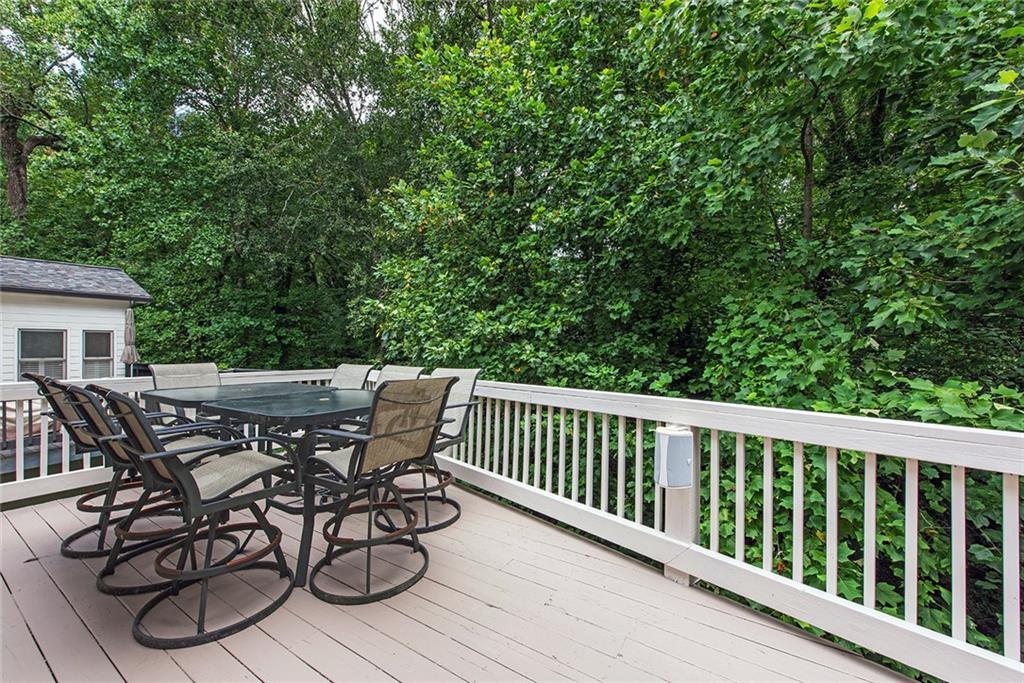 3854 Sidestreet Atlanta, GA 30341 - Photo 30 of 83 a view of a patio with table and chairs with wooden floor and fence