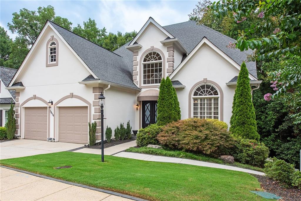3854 Sidestreet Atlanta, GA 30341 - Photo 4 of 83 a view of a yard in front of a house with plants and large trees
