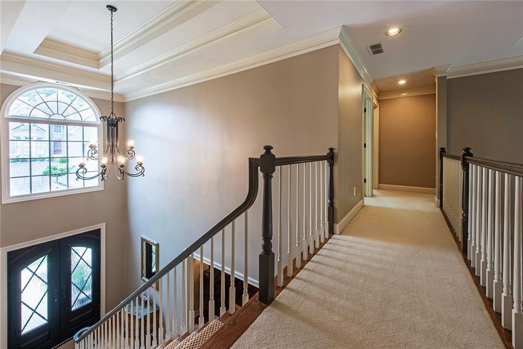 3854 Sidestreet Atlanta, GA 30341 - Photo 45 of 83 a view of a hallway with wooden floor and a chandelier