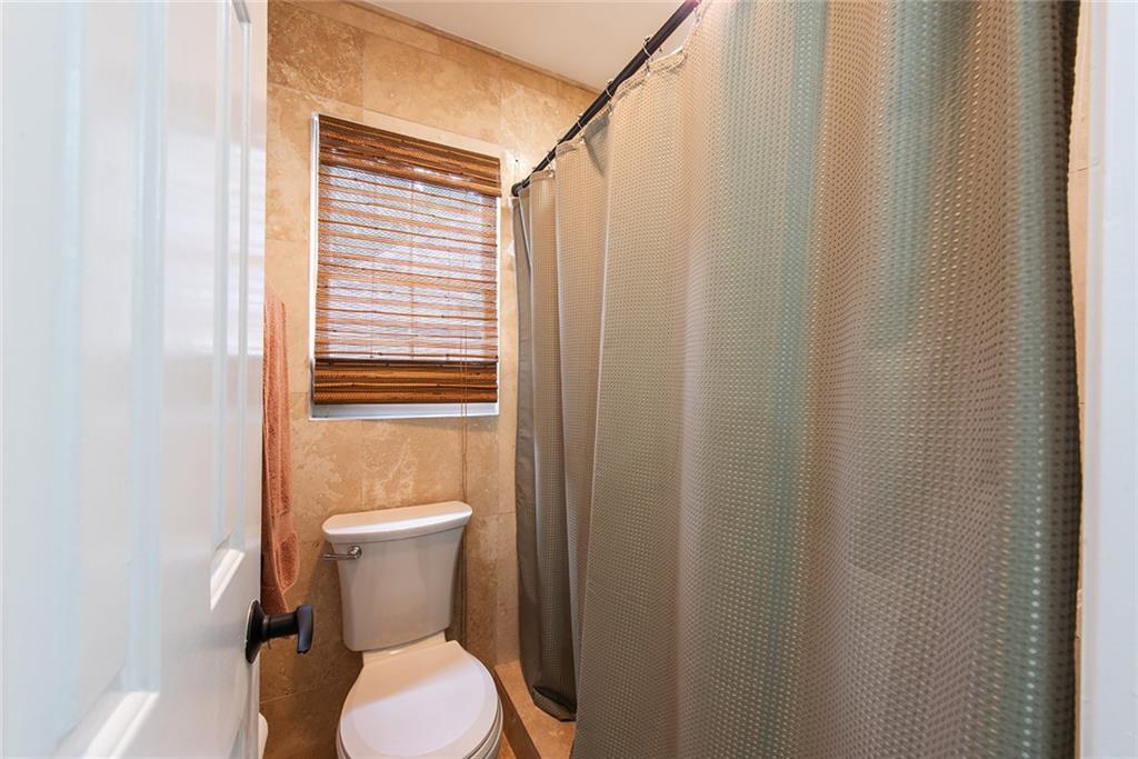 3854 Sidestreet Atlanta, GA 30341 - Photo 56 of 83 a white toilet sitting next to a shower curtain