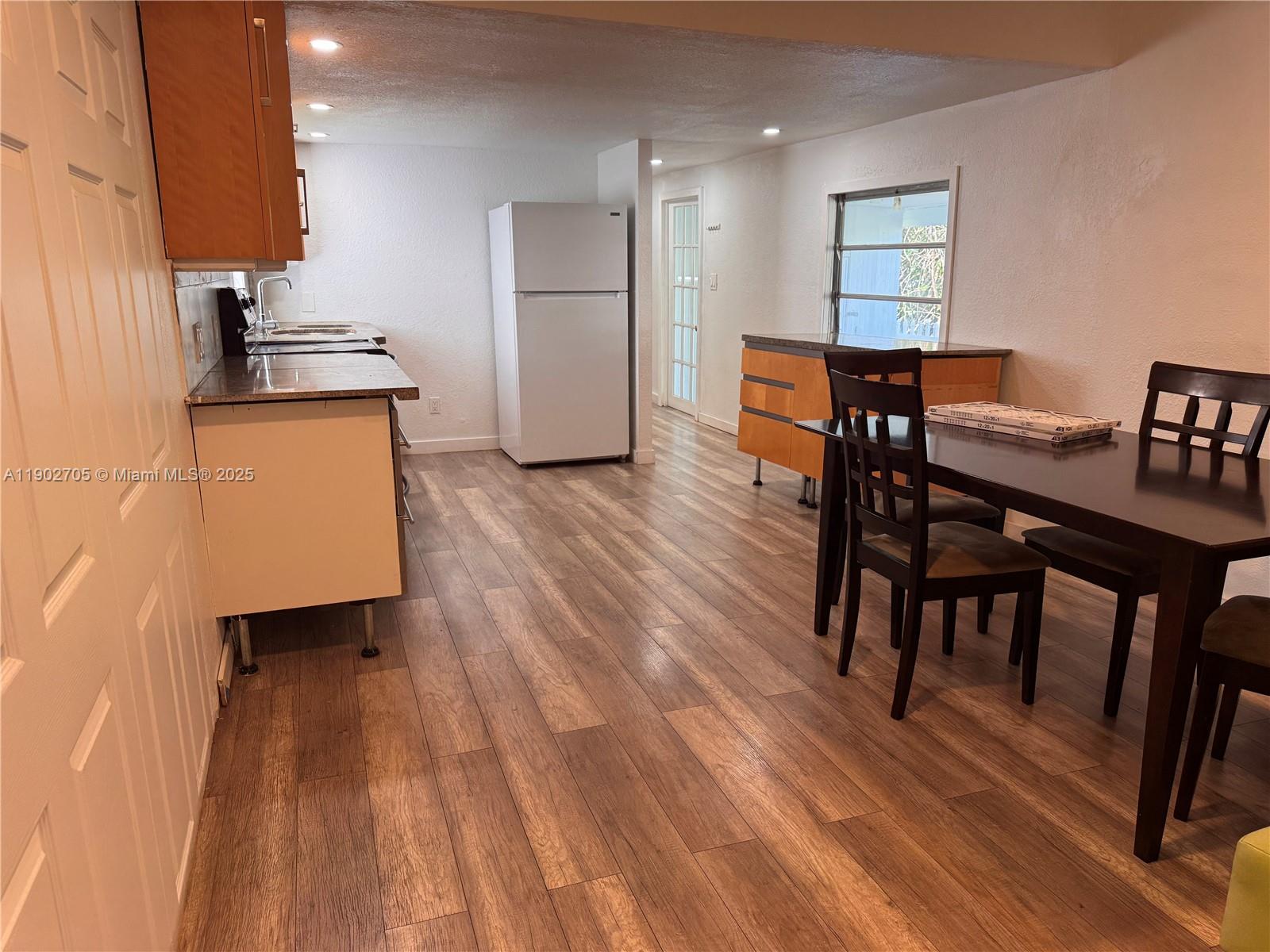 5331 Southwest 35th Street Davie, FL 33314 - Photo 4 of 21 a kitchen with a table chairs a sink and a stove