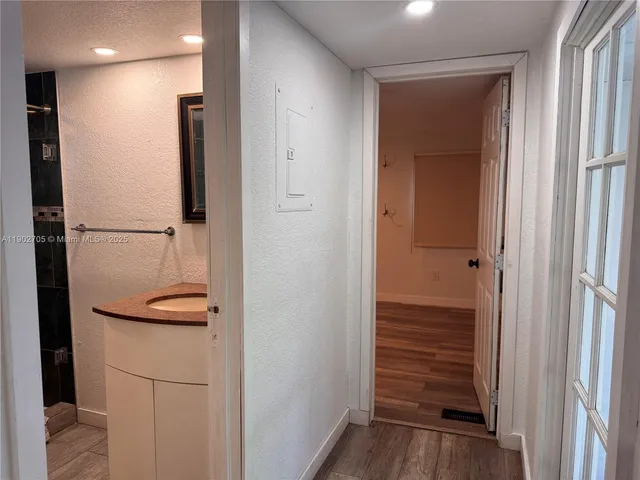 a view of a hallway with wooden floor