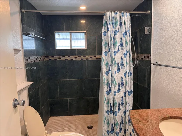 a bathroom with a shower and a toilet