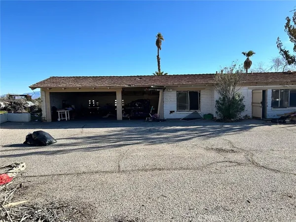 a view of house with outdoor space and parking
