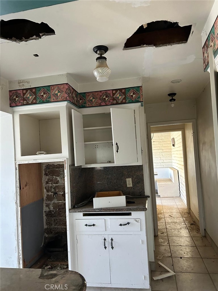 20572 Rancherias Road Apple Valley, CA 92307 - Photo 5 of 11 a kitchen with a cabinets and a stove top oven