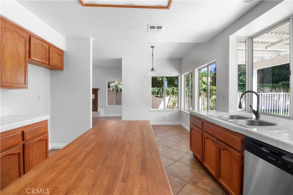 11189 Summerside Lane Rancho Cucamonga, CA 91737 - Photo 11 of 30 a kitchen with stainless steel appliances granite countertop a sink stove and refrigerator