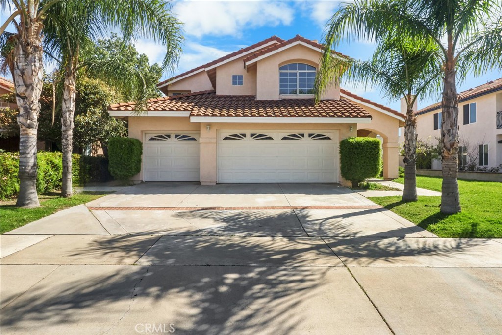 11189 Summerside Lane Rancho Cucamonga, CA 91737 - Photo 3 of 30 a front view of a house with a yard and garage