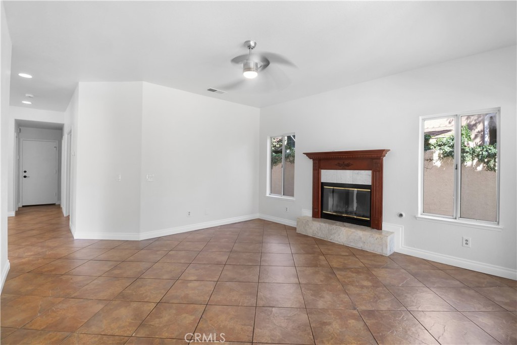 11189 Summerside Lane Rancho Cucamonga, CA 91737 - Photo 10 of 30 a view of an empty room with a fireplace and a window