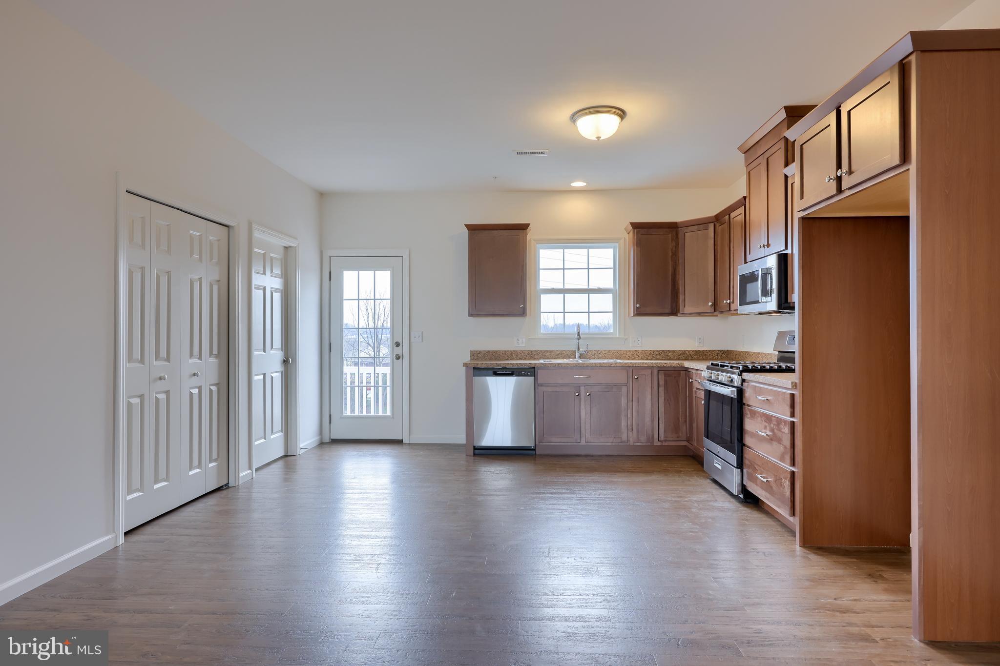2417 Spring Water Circle Lancaster, PA 17601 - Photo 19 of 35 a large kitchen with a wooden floor and a stove top oven