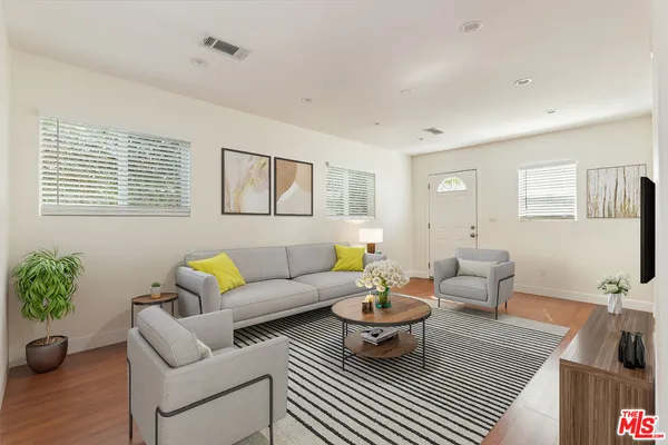 a living room with furniture potted plant and a window