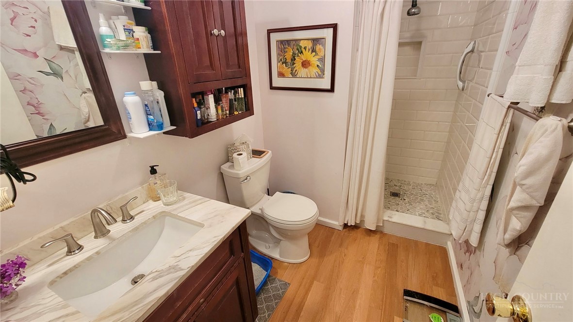 111 Locust Ridge Road Beech Mountain, NC 28604 - Photo 11 of 21 a bathroom with a sink a toilet and shower curtain