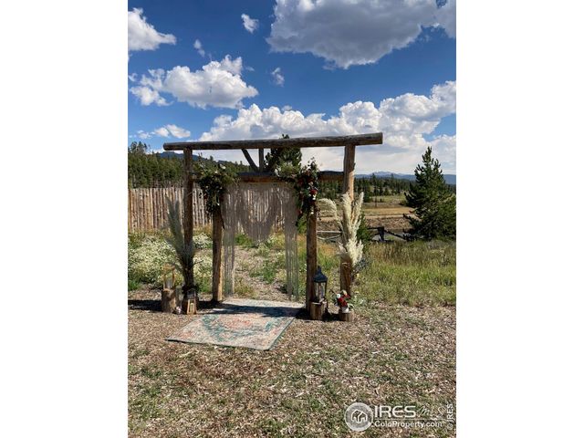 a dining room with furniture and a floor to ceiling window