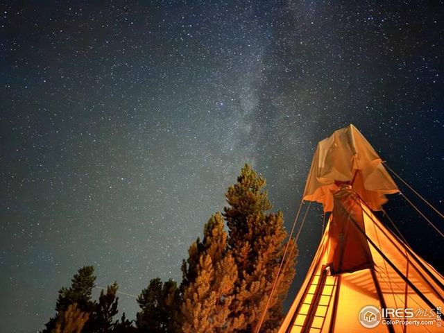 a view of a roof deck with table and chairs