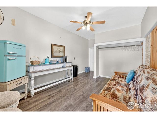 a bedroom with a bed next to a window