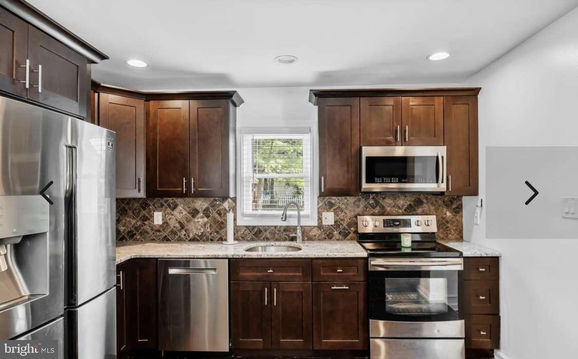 505 East Evesham Road Voorhees, NJ 08043 - Photo 6 of 18 a kitchen with stainless steel appliances a stove sink microwave and refrigerator