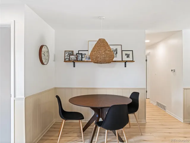 a view of a dining room with furniture and wooden floor