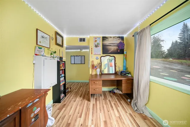 a view of work space with wooden floor and furniture