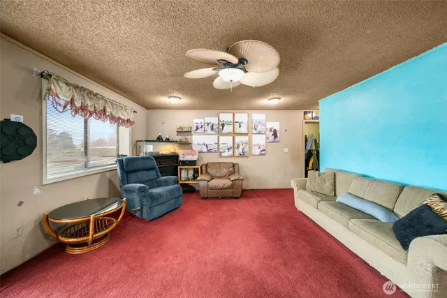 a living room with furniture gym equipment and a large window