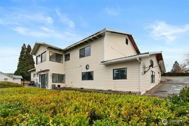a view of a white house with a yard