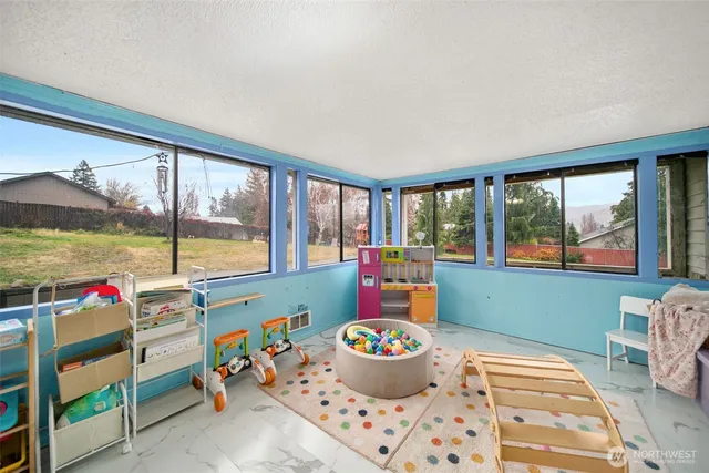 a living room with a large window and dining table
