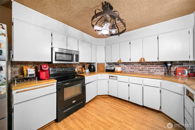 a kitchen with a sink stainless steel appliances and cabinets