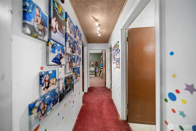a view of a hallway with furniture and toys