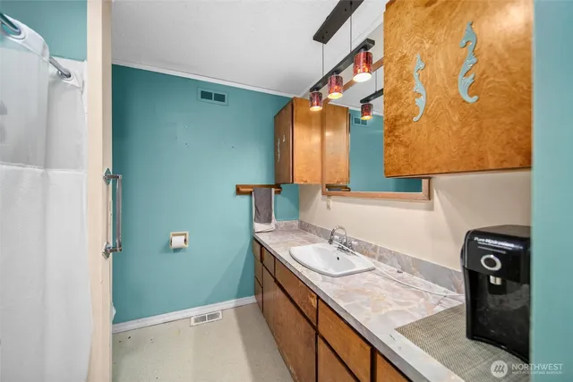 a bathroom with a granite countertop sink and a mirror