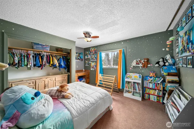 a bedroom with furniture and a baby crib