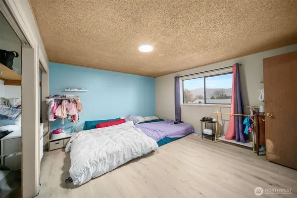 a bedroom with a bed and a large window