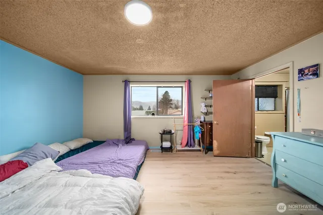 a bedroom with a large bed and a window