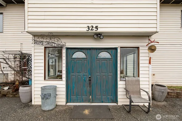 a front view of a house with outdoor seating
